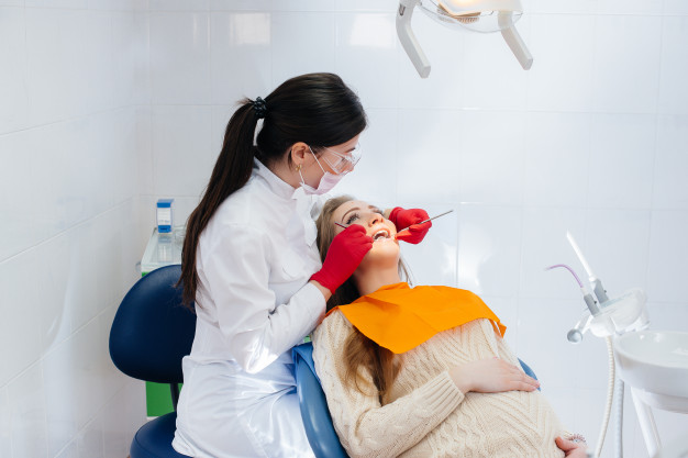 professional-dentist-treats-examines